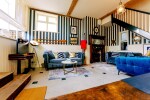 the living room showing the staircase up to the bedrooms