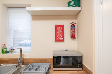 Kitchen with microwave and Fire blanket and Fire extinguisher