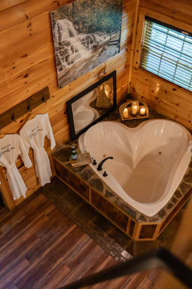a heart‑shaped tub glowing in candlelight — the smokies’ most romantic view.