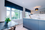Spacious living room with comfortable seating and inviting atmosphere, perfect for relaxing or socialising during your stay.