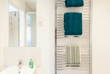Heated towel rail and towels in the master bedroom en-suite
