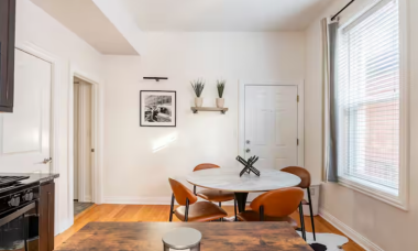 The dining and kitchen area combines style and function with a butcher block for extra prep space and a round table perfect for intimate dinners or lively meals with friends.