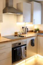 The fully equipped kitchen includes a single oven, four-burner hob, kettle, toaster and dishwasher, providing everything you need to prepare meals and enjoy a comfortable stay.