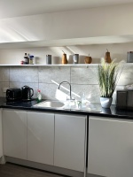 Lovely and light kitchen with original art by a Vogue featured artist and  all the pots, pans, utensils, crockery, plates, bowls, cutlery, appliances and space you need to cook a delicious meal for your stay! This kitchen is ready for you to cook in!