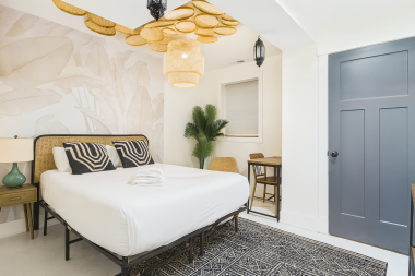 Primary bedroom with queen bed, custom lighting, and a calming palette designed for restful nights.