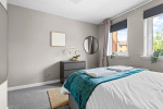 Double Bedroom with blackout blinds and curtains, and double wardrobe, chest of drawers and bedside tables