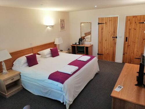 Double room with super king bed and ensuite bathroom with bath and shower