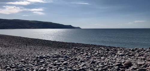 Bossington beach, pebbles and sea, with headlands in distance