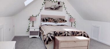 Spacious loft room approached by second flight of stairs.