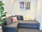 Luxury lounge with double sofabed, smart TV and air conditioning and original artwork