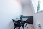 A comfortable sitting area with a table and chairs for relaxing or dining.