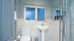 Clean, fresh and bright modern fitted bathroom, with walk in shower large mirror and a snuggly warm towel radiator.
