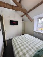 Exposed oak beams with smart tv bedroom