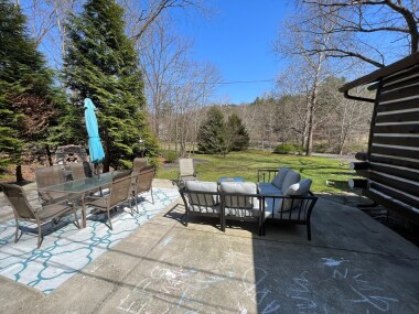 Lare patio with seating, table, firepit and BBQ grill