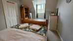 Whether you're travelling with family or friends, the fourth bedroom is a charming and practical space. With a double bed, plenty of storage, and a selection of books to enjoy, it's a welcoming retreat on the second floor.

