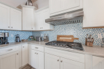 Kitchen has professional appliances including gas cooktop