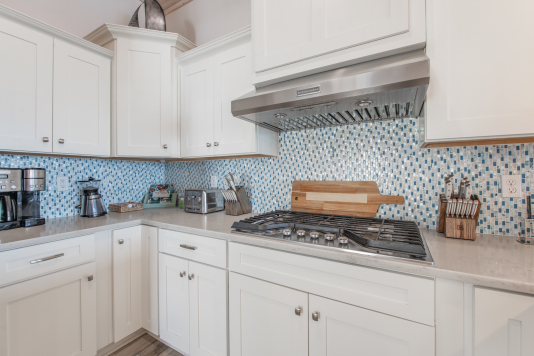 Kitchen has professional appliances including gas cooktop