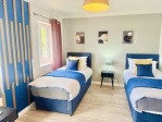 FIRST BEDROOM WITH THREE BEDS, TWO CAN BE LINKED TOGETHER
