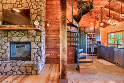 Fireplace, Spiral Staircase to Jacuzzi, with Kitchen beyond staircase, Soaring Eagle Luxury Treehouse