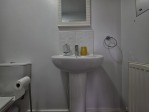 The second bedroom benefits from its own private en suite, featuring a toilet and a spacious walk-in shower. This added privacy makes it ideal for couples, older children, or any guest who appreciates a little extra space and convenience during their stay.