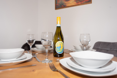 Thoughtful dining spaces with a spacious area between the kitchen and living room, seating 8 at the tables plus 4 at the breakfast bar, fully set with plates, cutlery and everything needed for the perfect dining experience - ask us about our in-house private chefs.