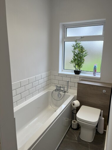 Bathroom with toilet, sink, bath & shower cubicle.
