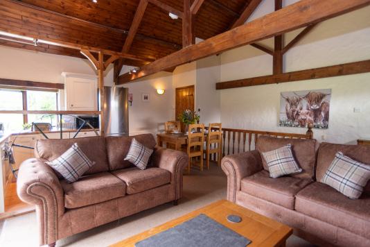 Open-Plan Living Under Vaulted Beams - The Wheel House's stunning A-frame ceiling and exposed timber trusses set the scene for this uniquely designed mill cottage, perfect for groups who want something genuinely one-of-a-kind