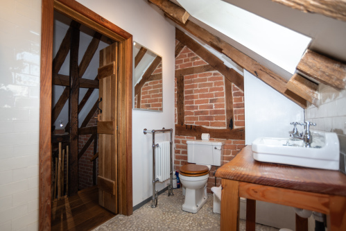 Upstairs master bathroom with rainfall shower, heated towel rail, sink and all essentials for a comfortable stay