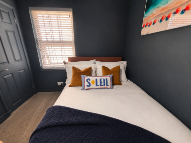 Comfortable second bedroom featuring a small double bed and built-in storage for your convenience.
