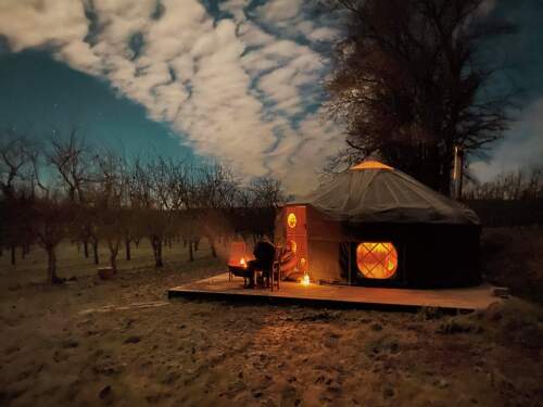 Cai Yurt by moonlight with firepit