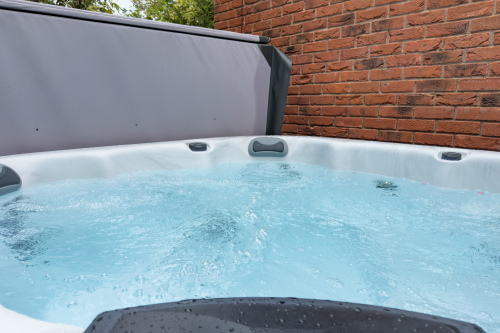 Private courtyard hot tub, freshly cleaned and ready for guests to sink into warm, soothing bubbles.
