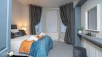 Bright Airy stylish bedroom, with hotel style linens, This room boasts high ceilings and original Cornice and large windows flooding the room with light. A comfortable space to rejuvenate.