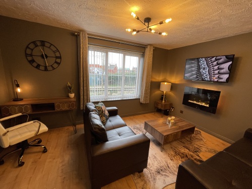 Open plan living area with flat screen TV and fireplace