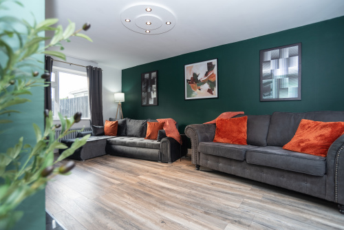 Spacious and welcoming living room with dual sofas, including a super-comfy double sofa bed with bedding prepared and ready for use.