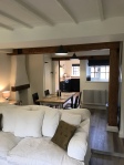 Comfortable sofa in living area with view of dining room and kitchen