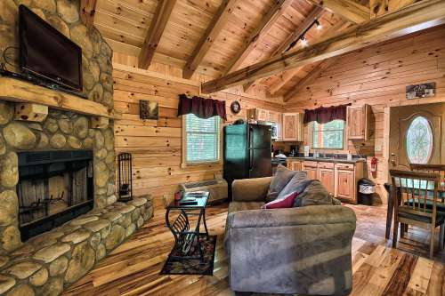 Looking toward Fireplace and Sitting area, Dining Table and Kitchen, from rear door