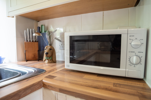 Fully equipped kitchen with oven, hob, microwave and ample preparation space for family meals and holiday favourites.