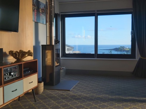 Log burner and sea views from large Lounge