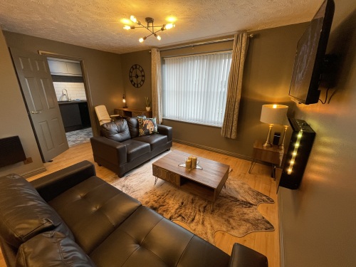 Open plan living area with flat screen TV and fireplace