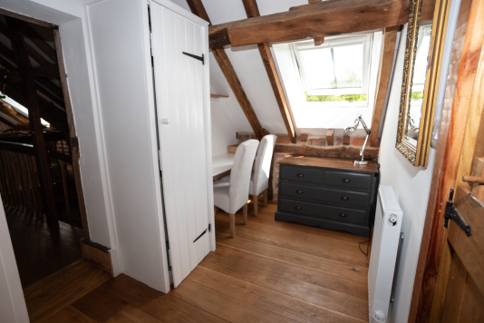 Upstairs dressing area with wardrobe, desk, mirrors, great lighting and a supplied hairdryer — perfect for getting ready for Hereford’s restaurants and nightlife, just 10 mins away