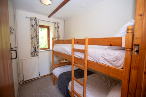 Perfect for families, the bunk bedroom offers a practical and comfortable space for children or additional guests during your North Devon getaway.