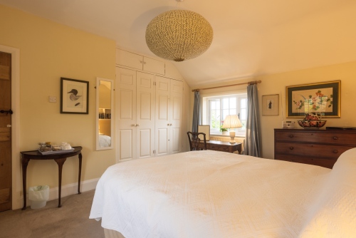 The large master bedroom room has a king size bed, down duvet and pillows.