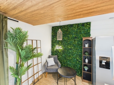 A lush green wall adds a touch of nature indoors, creating a serene corner for morning espresso.