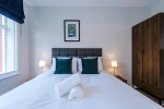 Spacious living room with comfortable seating and inviting atmosphere, perfect for relaxing or socialising during your stay.