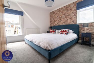 Master bedroom with navy super king size velvet bed and Tempur mattress