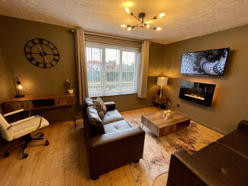 Open plan living area with flat screen TV and fireplace