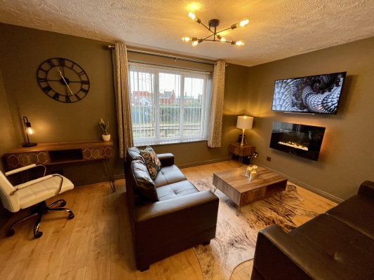 Open plan living area with flat screen TV and fireplace