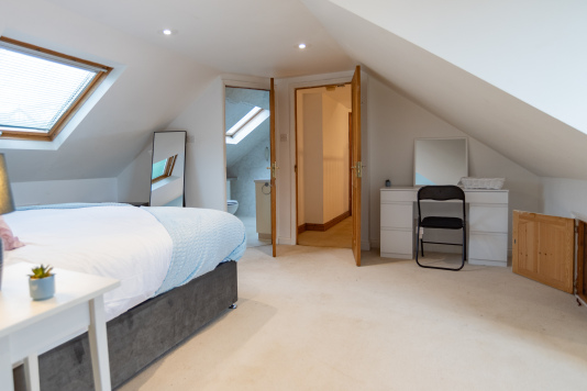 View from the master bed, featuring a dressing table, walk-in wardrobe, and private en-suite for a comfortable, well-designed stay.