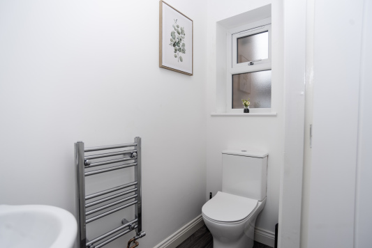 Downstairs WC with heated towel rail, handwash and fresh towels all supplied — clean, convenient and perfect for busy mornings.