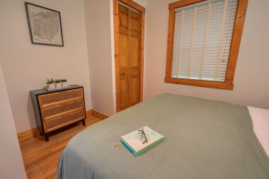 Primary bedroom storage with luggage rack and closet